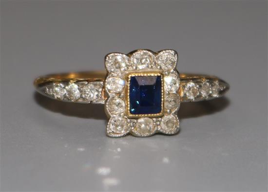 An 18ct gold sapphire and diamond tablet ring, with diamond set shoulders, size T.